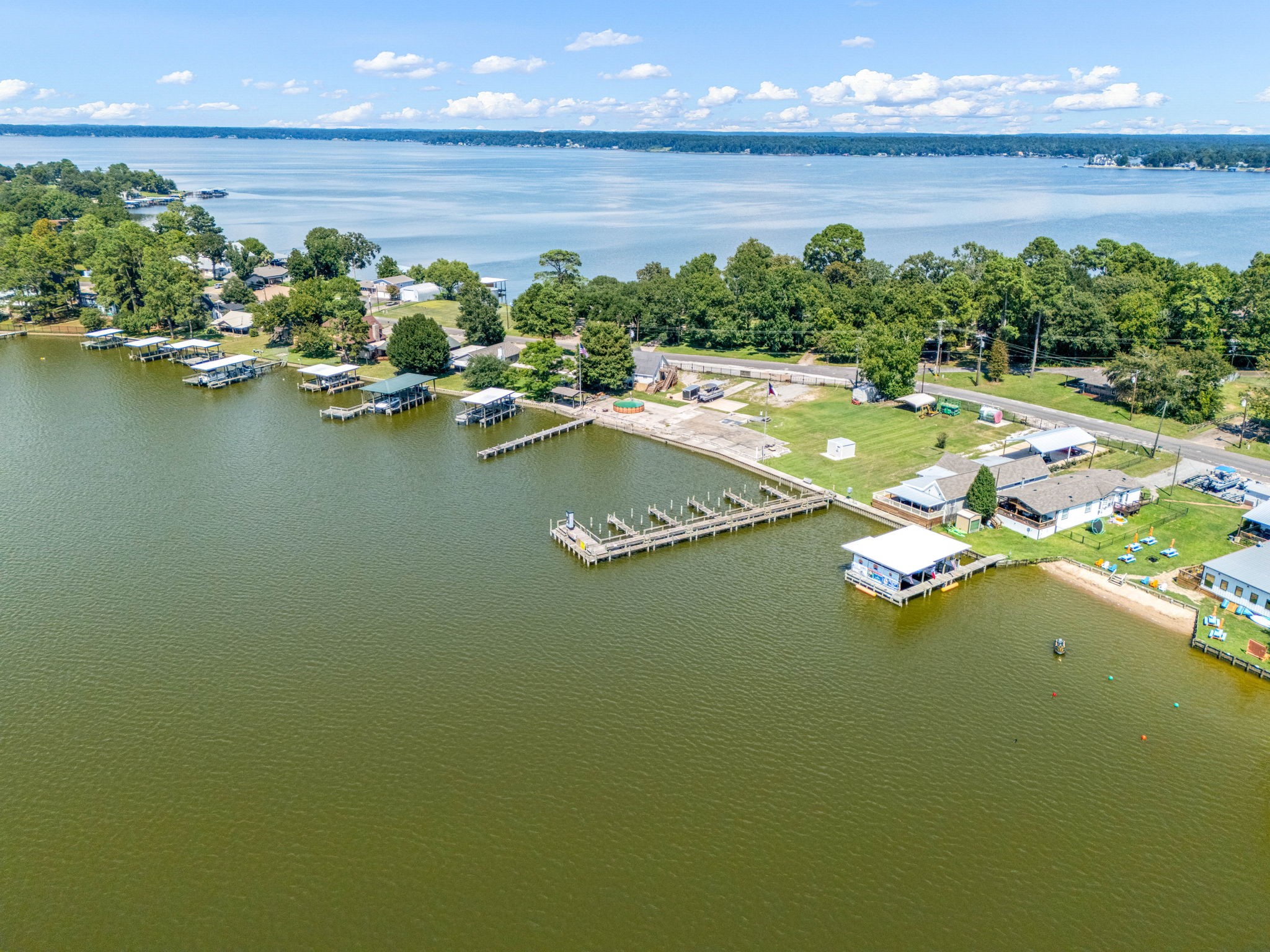 1100 Reveille Road Livingston, TX 77351 - Photo 17 of 20 a view of a lake with lawn chairs