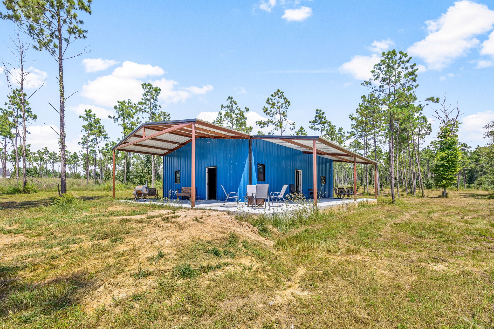 1100 Reveille Road Livingston, TX 77351 - Photo 6 of 20 a front view of a house with a garden