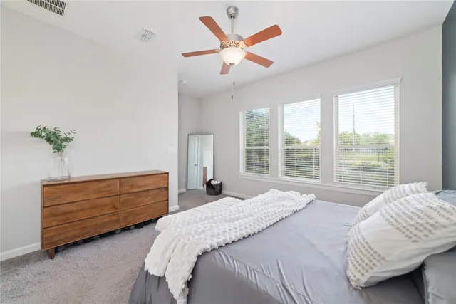 a bedroom with a bed dresser and a window