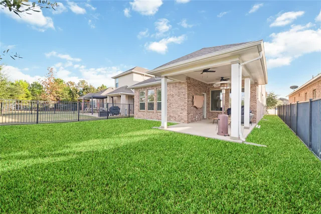 a view of a house with a backyard
