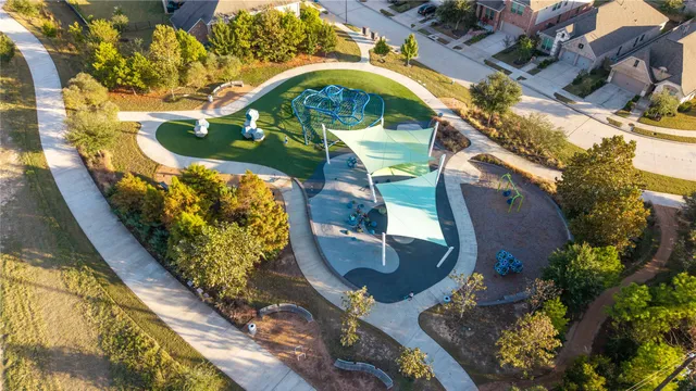 a view of a house with a yard and a large tree