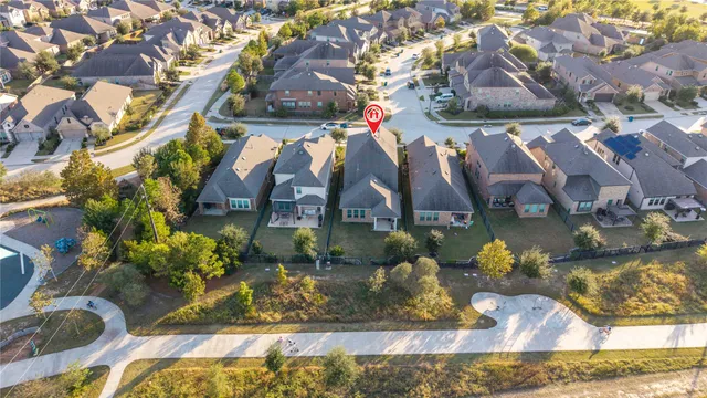 an aerial view of residential houses with outdoor space and street view