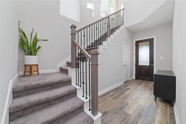 a view of entryway and hall with wooden floor