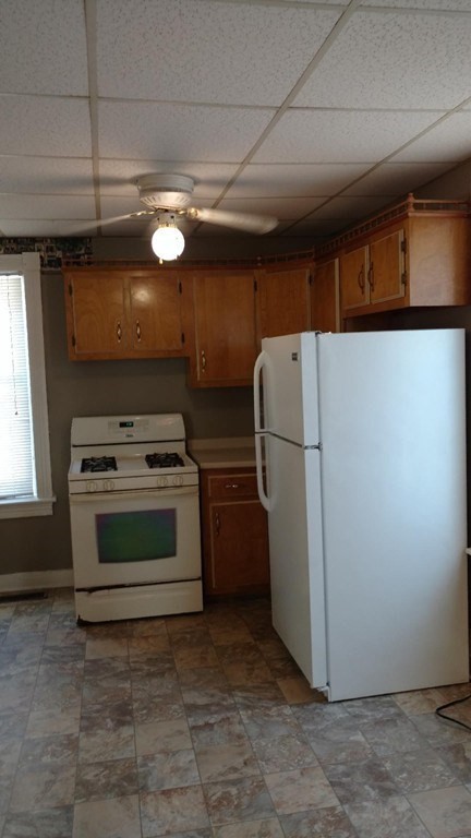 a kitchen with refrigerator and a stove