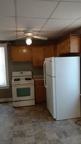 a kitchen with refrigerator and a stove