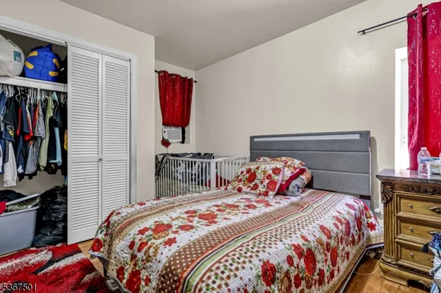 a bedroom with bed and a closet