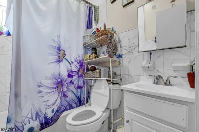 a bathroom with a sink toilet and mirror