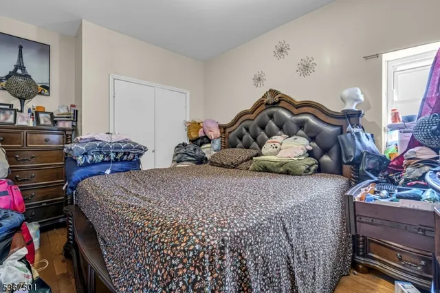 a bedroom with bed and a potted plant
