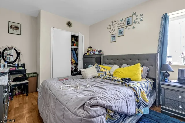 a bed room with a bed and painting on the wall