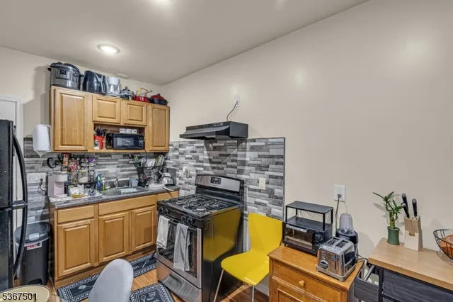 a kitchen with a stove and a refrigerator