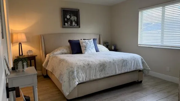 a bed sitting in a bedroom next to a window