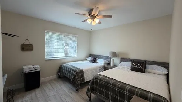 a bedroom with two beds and a window