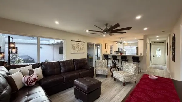 a living room with furniture and a large window