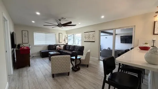 a living room with furniture and a wooden floor