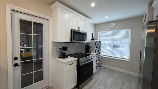a kitchen with granite countertop a stove and a microwave