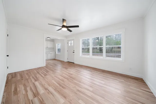 a kitchen with granite countertop white cabinets and white appliances
