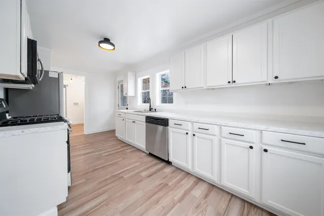 a kitchen with a refrigerator and a stove top oven