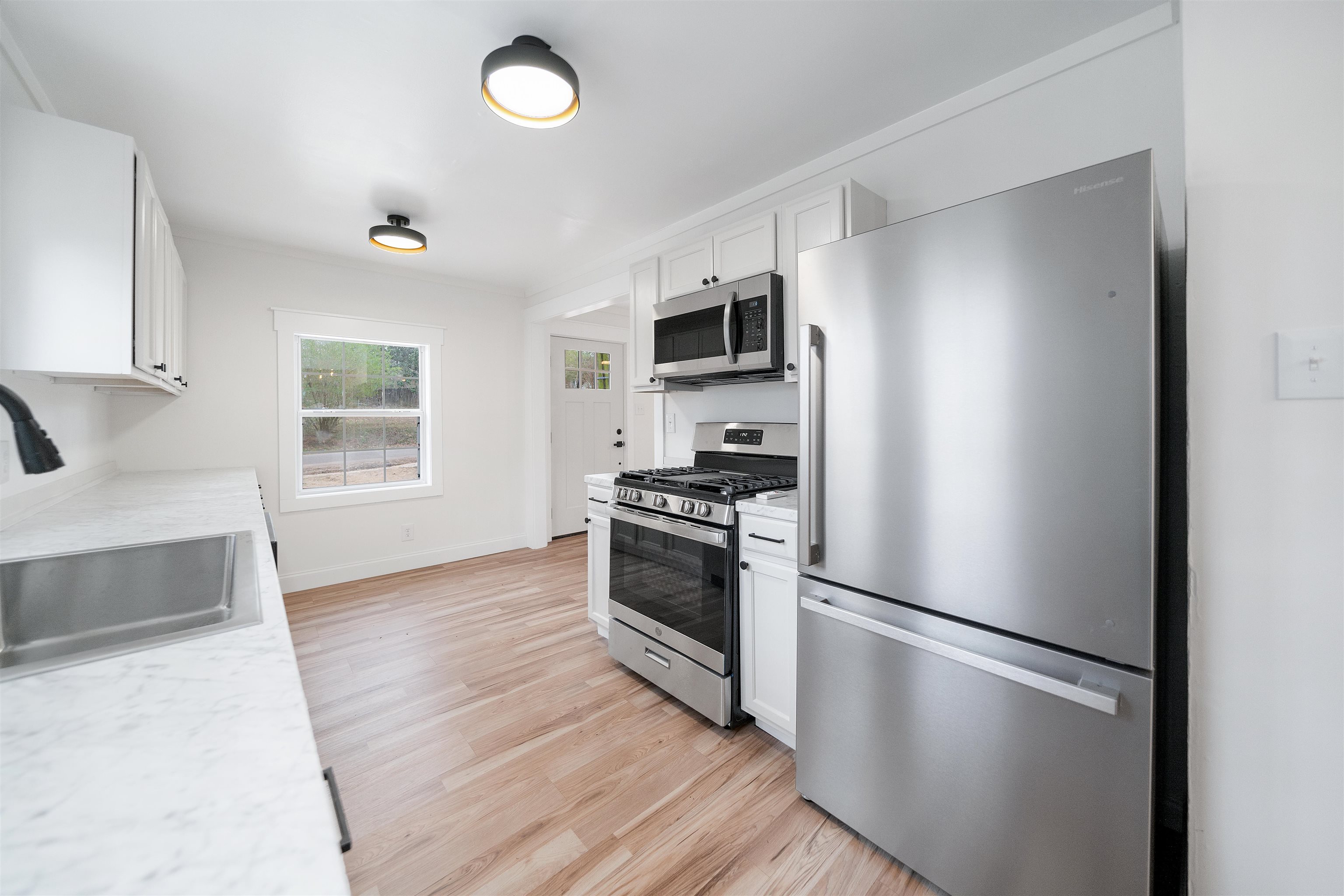 231 Adams Selmer, TN 38375 - Photo 19 of 24 a kitchen with a refrigerator and a stove top oven