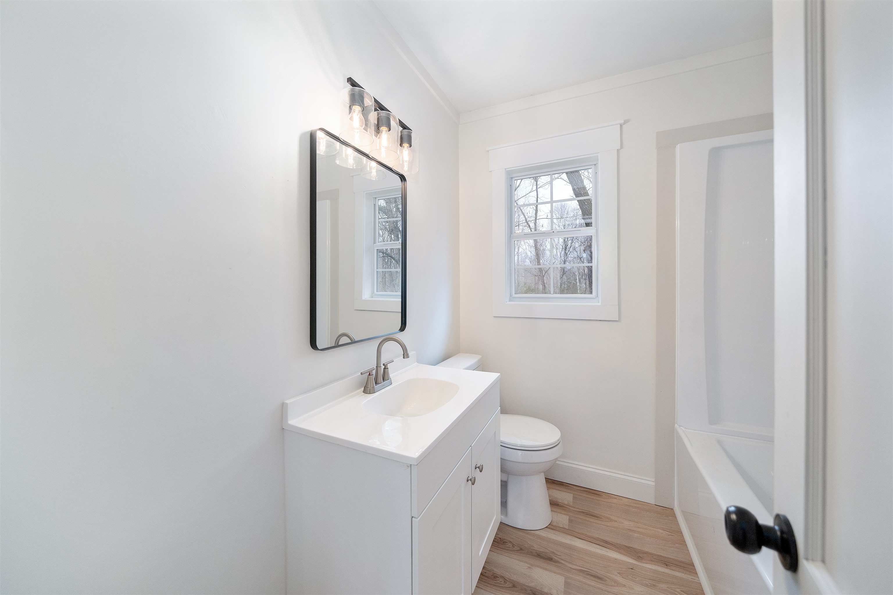 231 Adams Selmer, TN 38375 - Photo 24 of 24 a bathroom with a toilet a sink and mirror