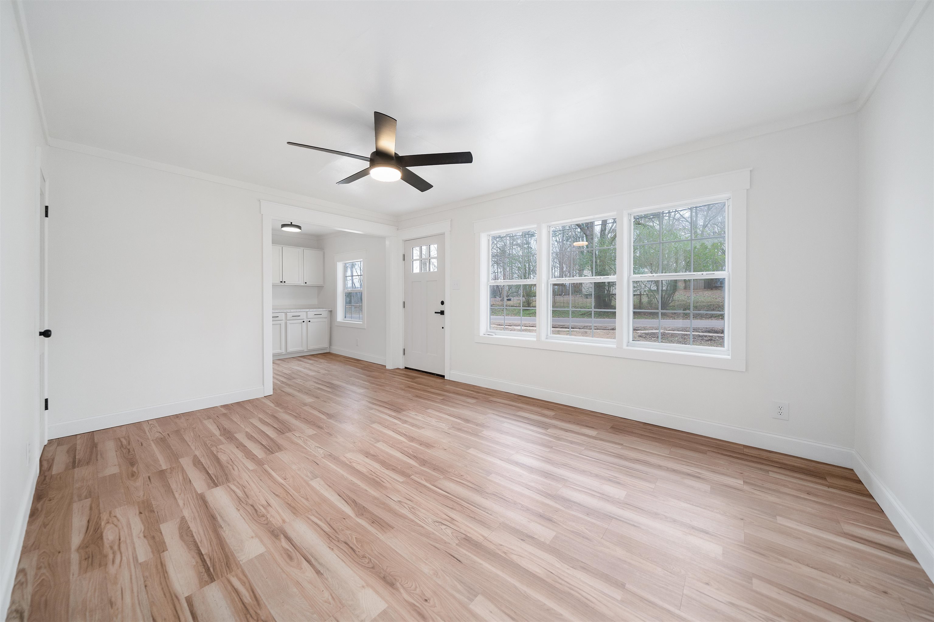 231 Adams Selmer, TN 38375 - Photo 10 of 24 a view of empty room with wooden floor and ceiling fan