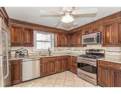 6 Philips Road Stoneham, MA 02180 - Photo 11 of 25 a kitchen with stainless steel appliances granite countertop a stove sink and cabinets