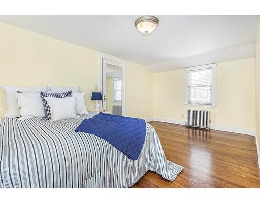 6 Philips Road Stoneham, MA 02180 - Photo 16 of 25 a bedroom with a bed and wooden floor