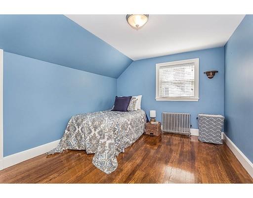 6 Philips Road Stoneham, MA 02180 - Photo 18 of 25 a bedroom with a bed and wooden floor