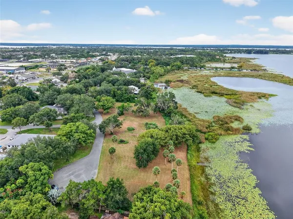 an aerial view of a city with lots of residential buildings ocean and mountain view