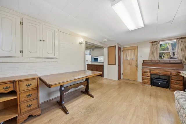 a living room with furniture and a kitchen