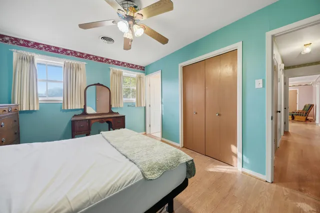 a bedroom with a bed and a chandelier