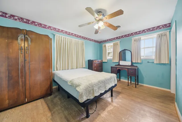 a living room with a bed furniture and a large window