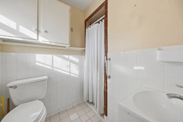 a bathroom with a toilet and a shower