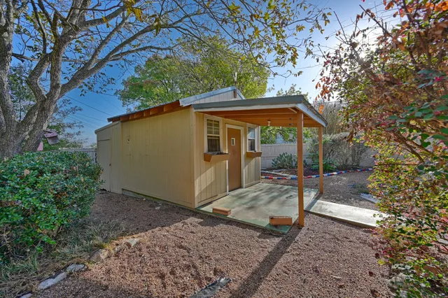 a view of a small house in the forest
