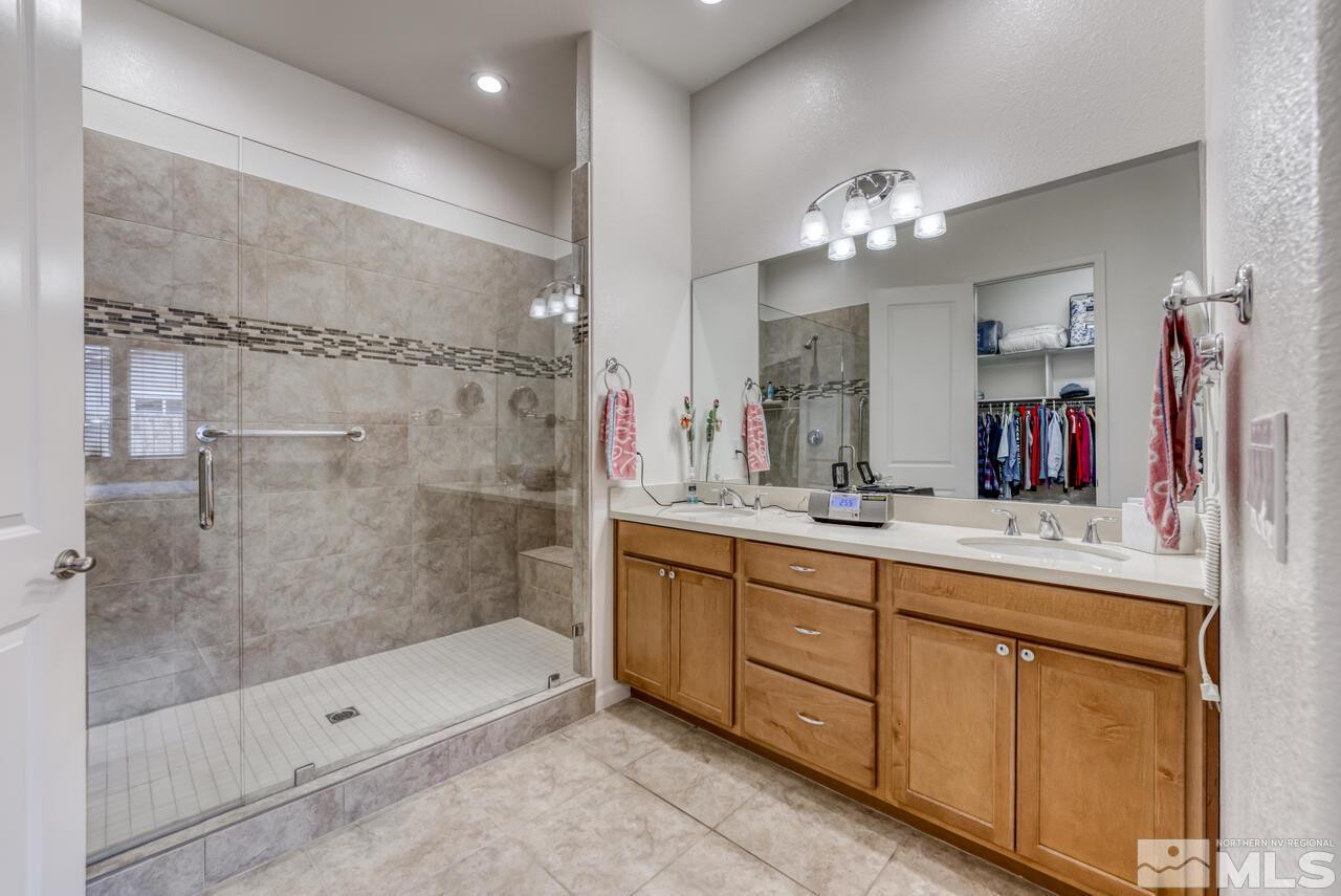 9950 Bernborough Drive Reno, NV 89521 - Photo 12 of 29 a bathroom with a double vanity sink mirror and shower