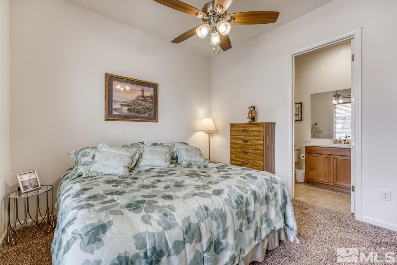 9950 Bernborough Drive Reno, NV 89521 - Photo 13 of 29 a bedroom with a bed and a chandelier