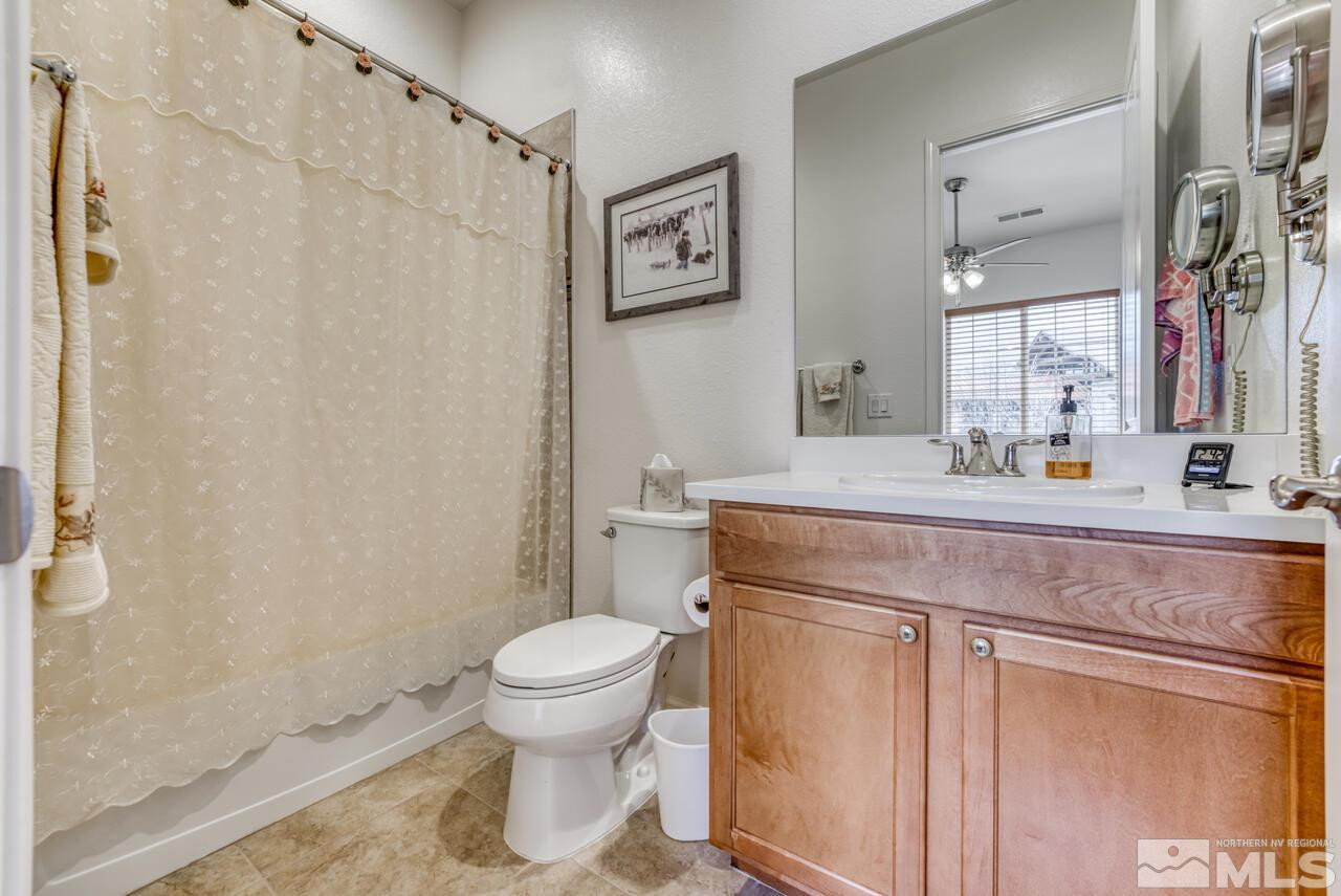 9950 Bernborough Drive Reno, NV 89521 - Photo 14 of 29 a bathroom with a sink toilet and shower