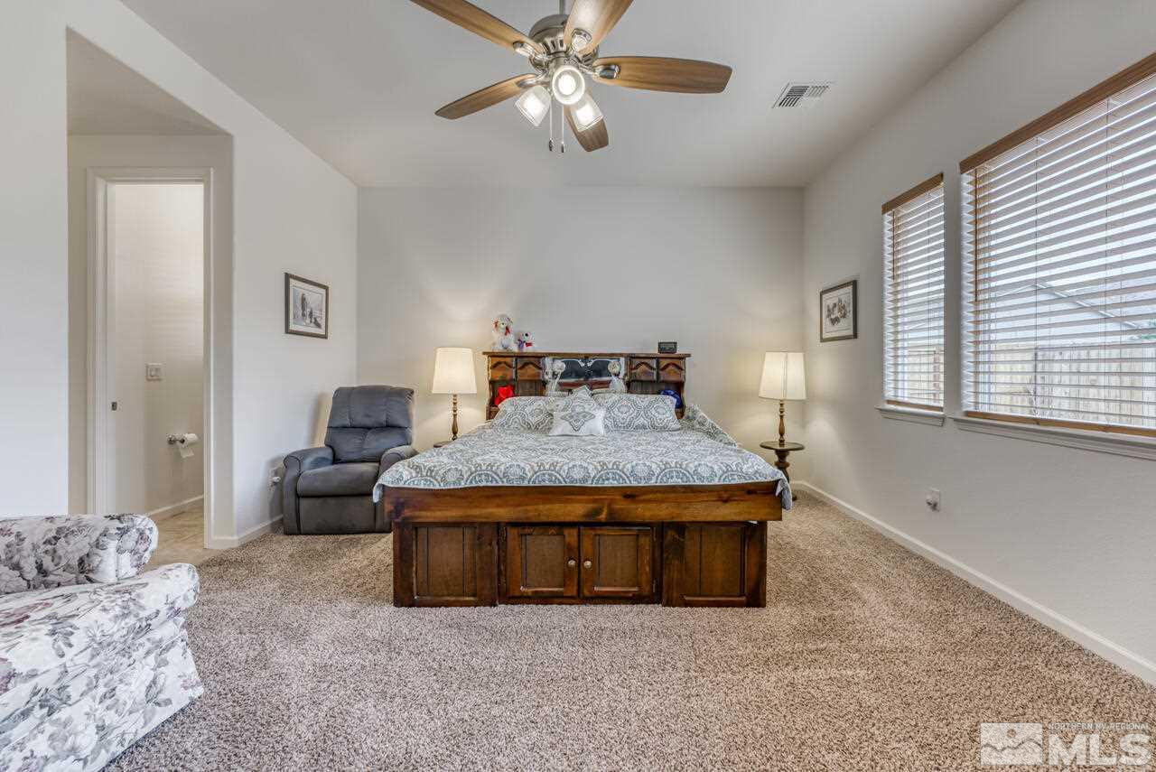 9950 Bernborough Drive Reno, NV 89521 - Photo 10 of 29 a living room with furniture and a chandelier