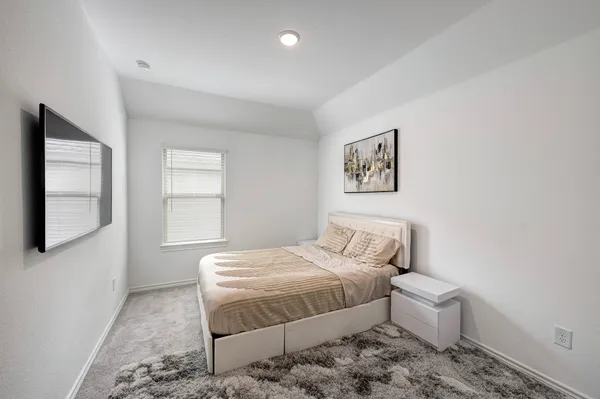 a bedroom with a bed and a window