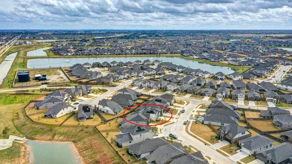 an aerial view of residential houses with outdoor space