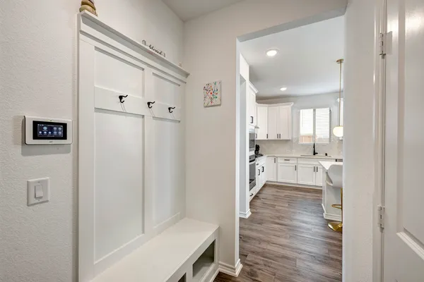 a view of a kitchen with a refrigerator and a stove top oven