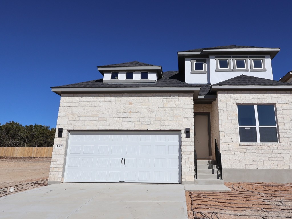 a front view of a house with garage