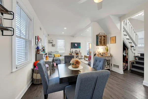 a view of a dining room with furniture and wooden floor