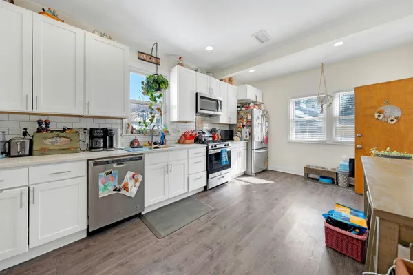 a bathroom with a sink a toilet and a shower curtain