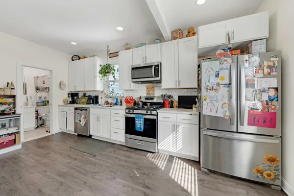 a utility room with dryer washer and a view of living room