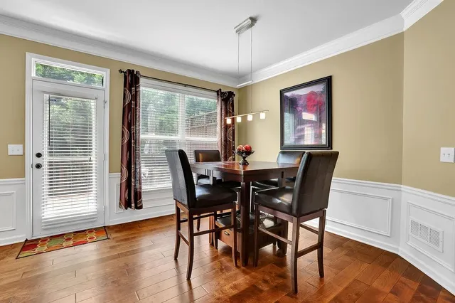 a view of a dining room with furniture window and wooden floor