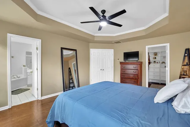 a bedroom with a bed and a view of kitchen