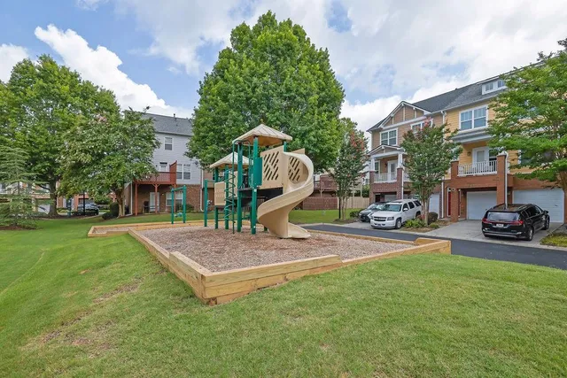 a view of a park with plants and a bench