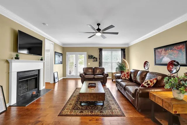 a living room with furniture a flat screen tv and a fireplace