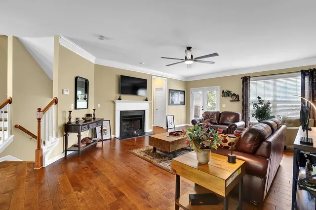 a living room with furniture a fireplace and a flat screen tv