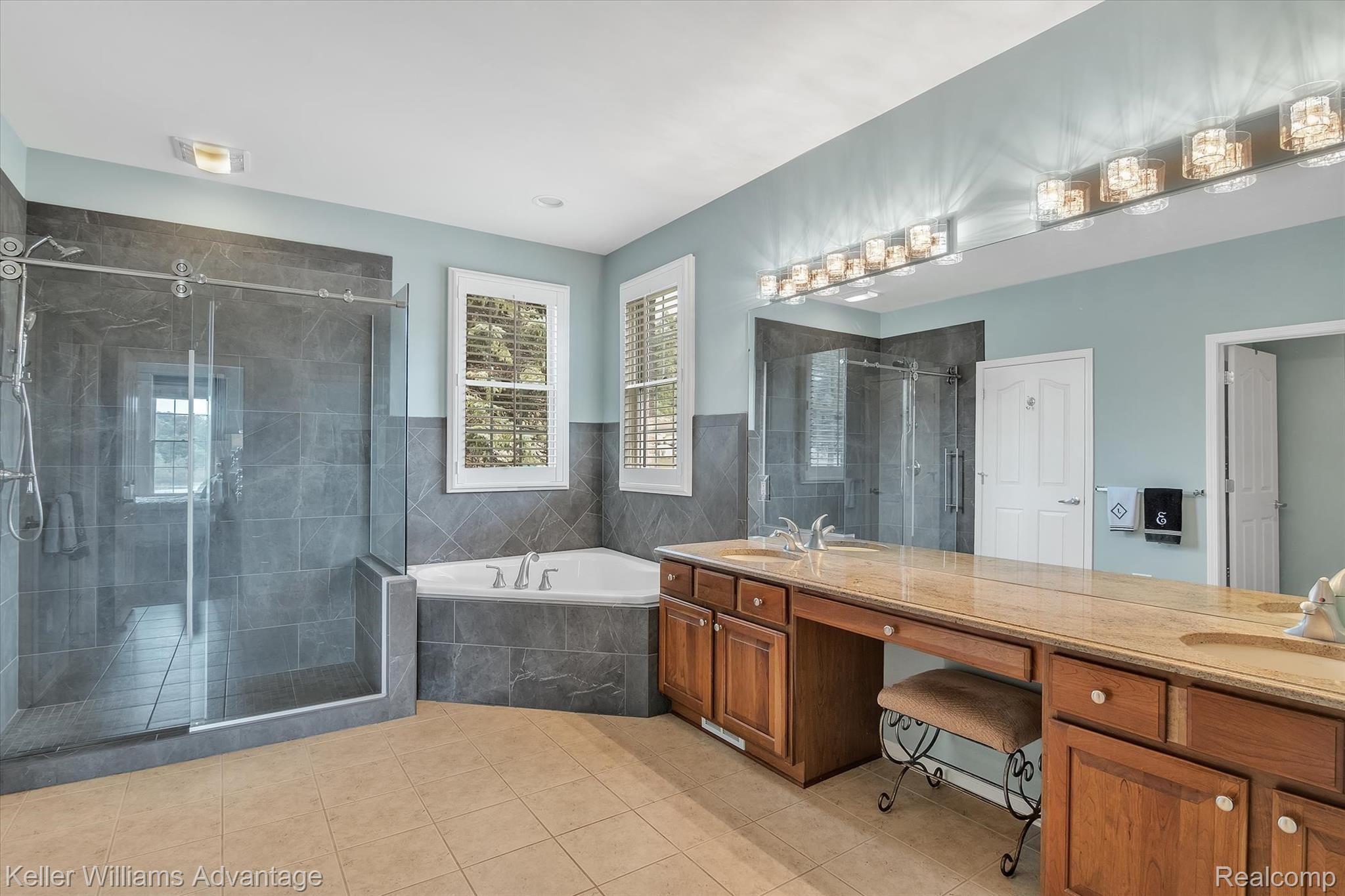 9042 Ridgefield Drive Brighton, MI 48114 - Photo 36 of 61 Master bath with dual granite vanity, dual walk-in closets, Jetted hot tub, and newly remodeled imported tile glass enclosed shower